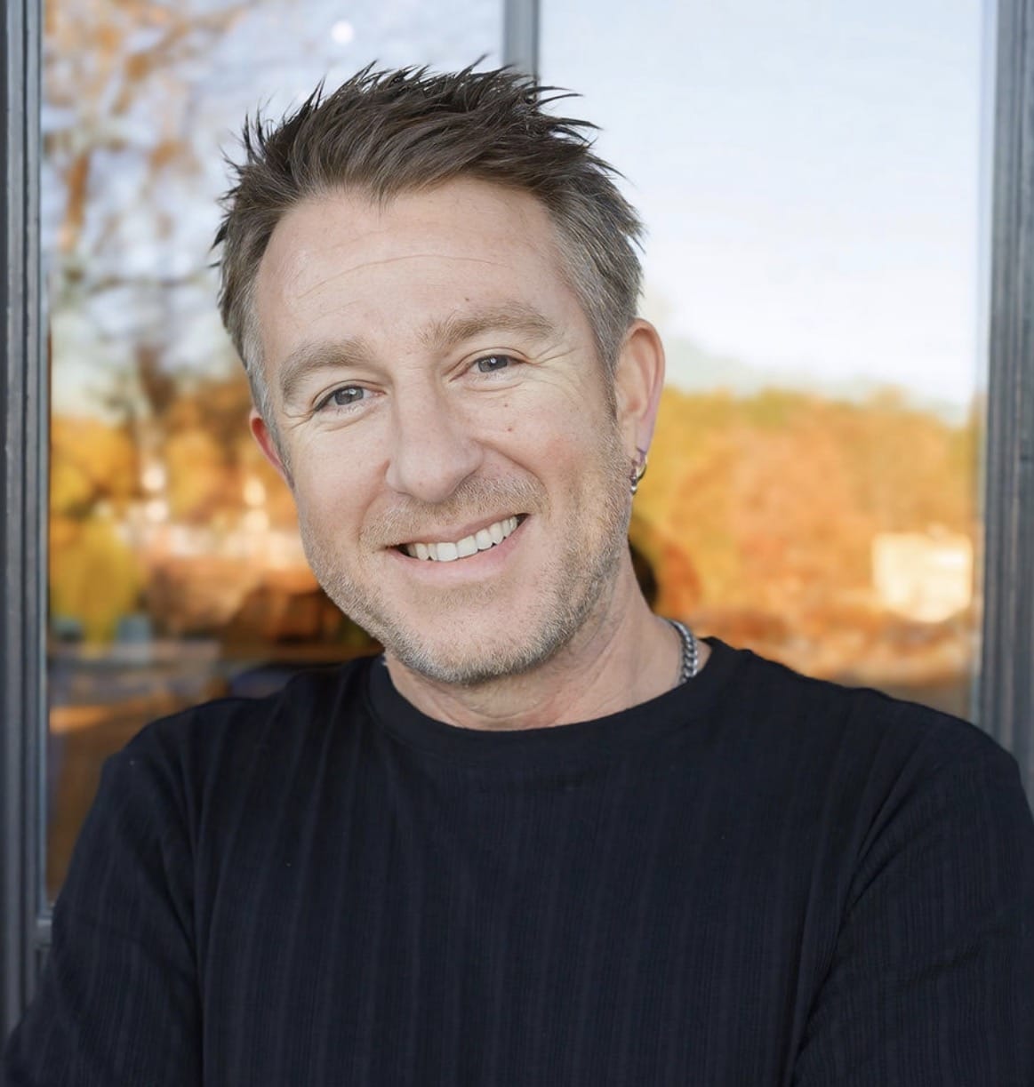 Ryan Reed smiling and looking at the camera