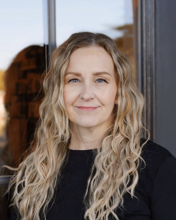 Jennifer Truscello standing in front of a window