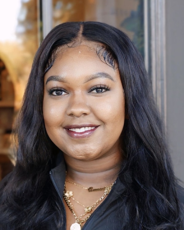 Queen Robinson smiling for the camera